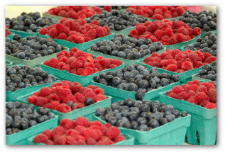 containers of raspberries and blueberries