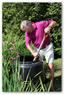 stirring compost barrel contents