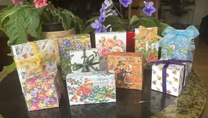 Free printable gift boxes in garden, flower, Thanksgiving, and Christmas designs, tied with ribbon and raffia
