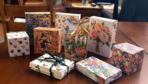 Free printable gift boxes in garden, flower, Thanksgiving, and Christmas designs on a dining table